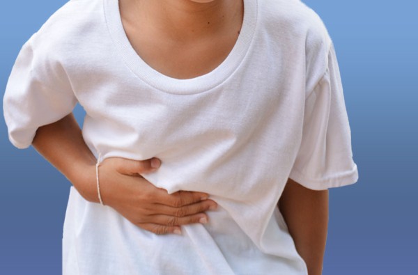 Child holding stomach in pain
