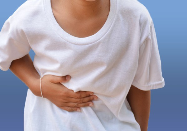 Child holding stomach in pain